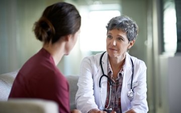 Doctor and patient having serious health conversation