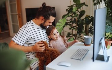 Father and daughter working together at home