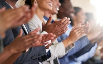 Employees clapping together