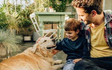 A parent and child with their dog