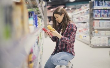 Woman choosing sunscreen lotion