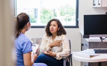 Adult female patient talks with nurse