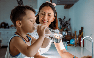 Woman and Child Drinking Water