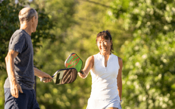 Individuals playing pickleball