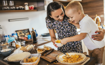 Mother and son making food together