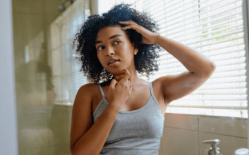 Woman conducting a self-exam of her skin