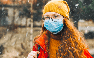 young girl masking to prevent spread of covid