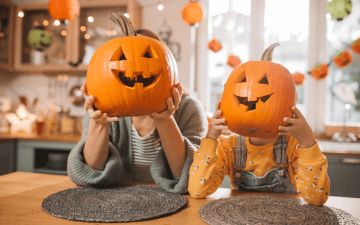 family after carving their pumpkins into jack o lanterns