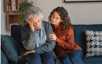 Young woman caring for an older woman with alzheimers