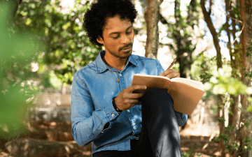 man journaling outside