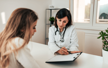 Doctor and patient sitting at a table going over test results