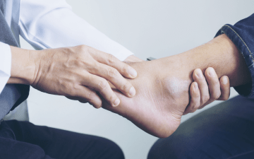 podiatrist holding patient's foot