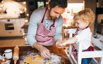 dad baking cookies with his child