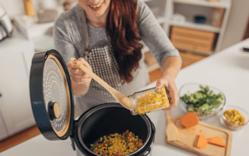 woman preparing a meal with a slow cooker