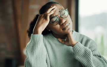 woman holding her head during a migraine