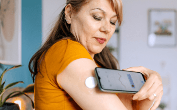woman checking her blood sugar using an app