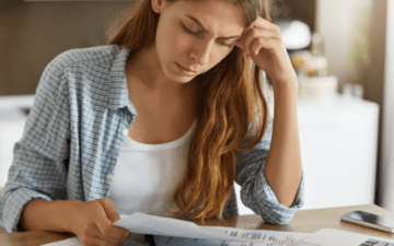 woman looking at bills