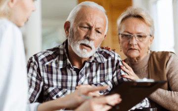 senior couple looking at clipboard