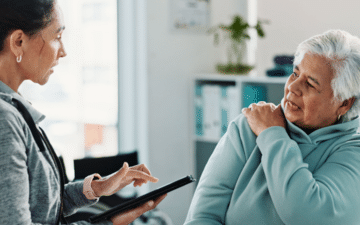 Woman speaking with a chiropractor about shoulder pain