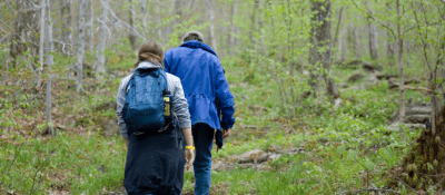two hikers walking in the forest