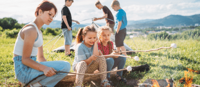 family camping, setting up a tent and roasting marshmallows