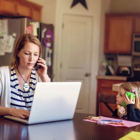 Mother and child at the table on their phones