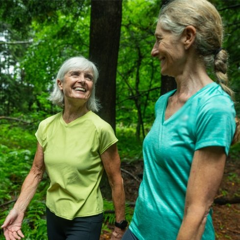 Two women walking in the woods in Vermont