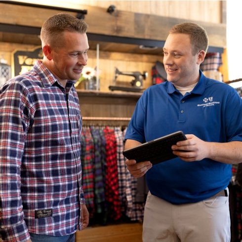 Blue Cross VT representative talking to Vermont Flannel employee
