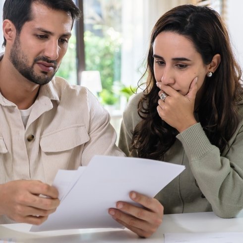 Couple looking at healthcare bill