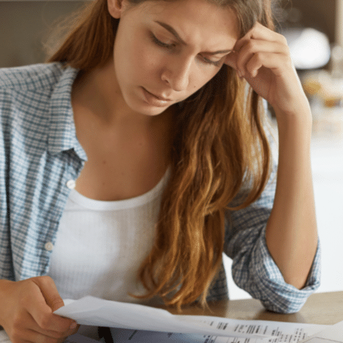 woman looking at bills