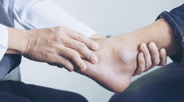 podiatrist holding patient's foot