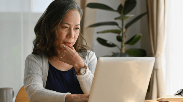 woman looking at computer contemplatively