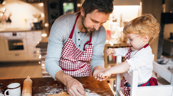 dad baking cookies with his child
