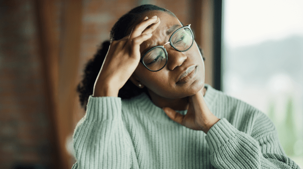 woman holding her head during a migraine