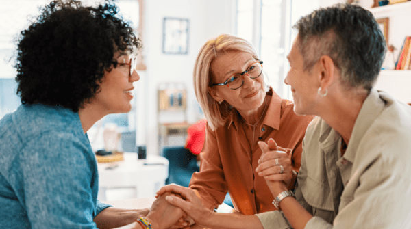 three women having a deep conversation