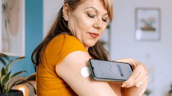 woman checking her blood sugar using an app