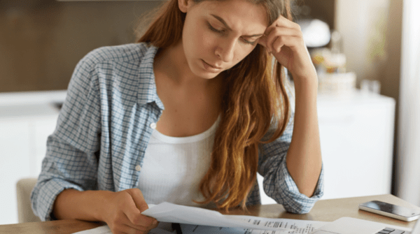 woman looking at bills