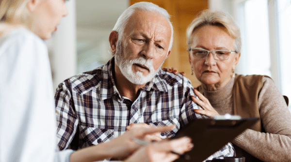 senior couple looking at clipboard