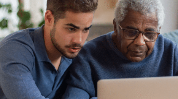 man helping his father use the computer