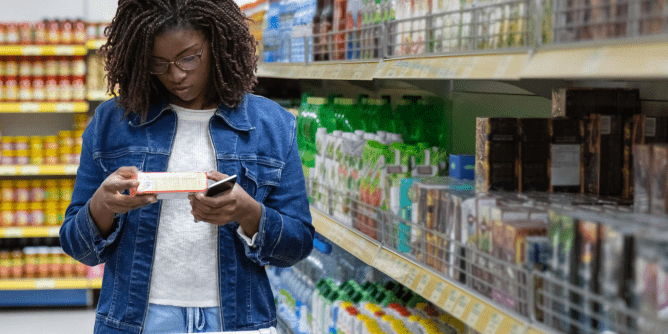 woman looking at labels while grocery shopping