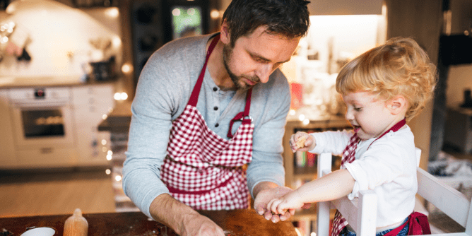 dad baking cookies with his child