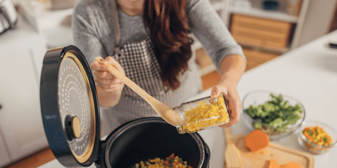 woman preparing a meal with a slow cooker