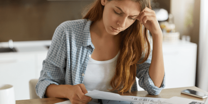 woman looking at bills