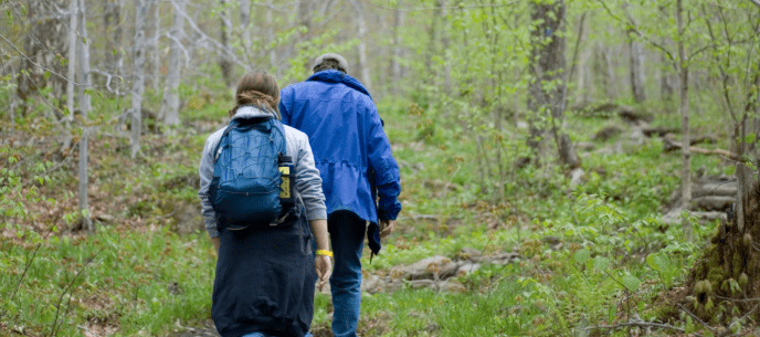 two hikers walking in the forest