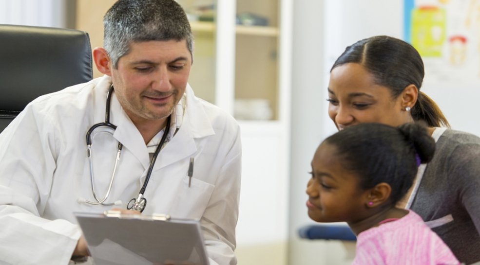 doctor talking to parent and child