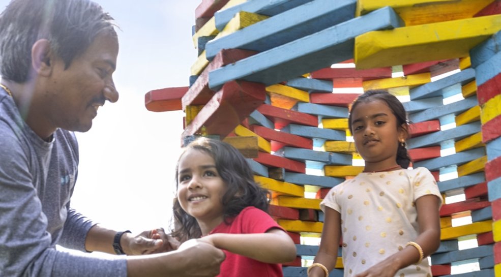 father with two kids playing outside