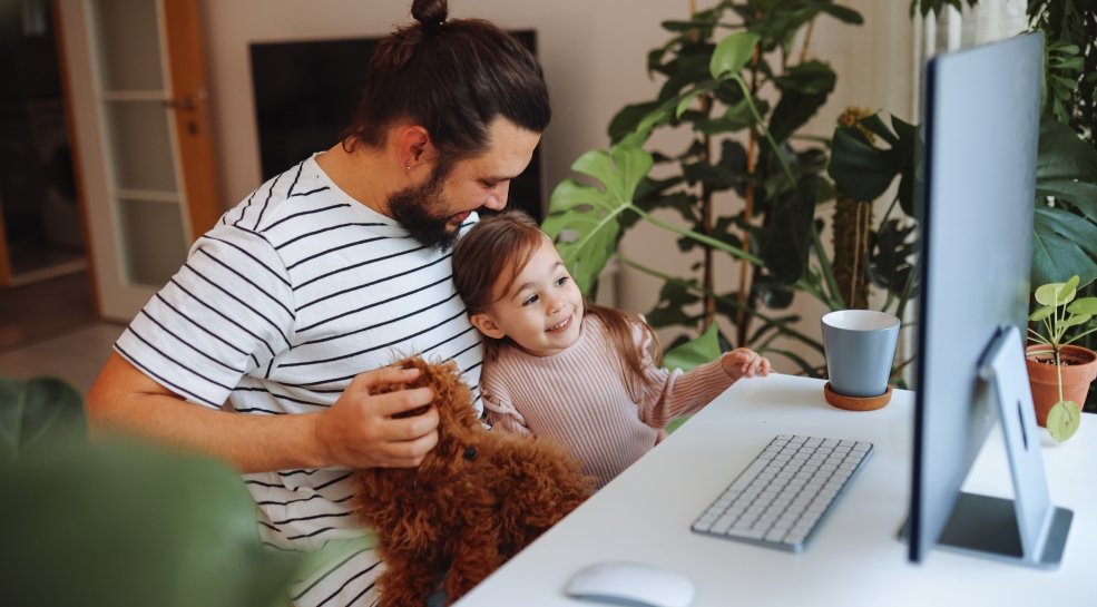 Father and daughter working together at home