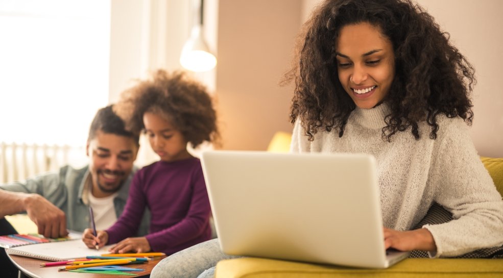 Mother working from home while dad and daughter having fun laptop computer work family