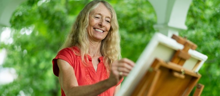 Woman painting on her porch