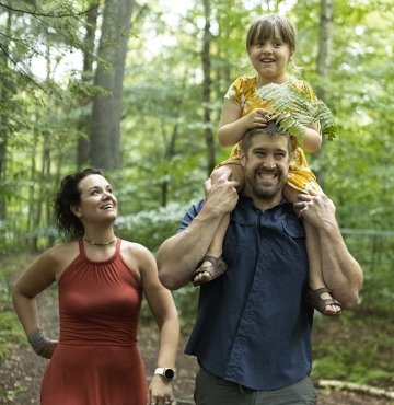 family walking in the woods